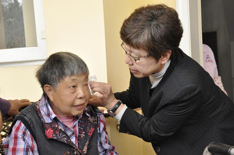 日本新泻冈田史教授在成都晚霞爱心护理院演示如何正确帮助老人擦洗眼睛